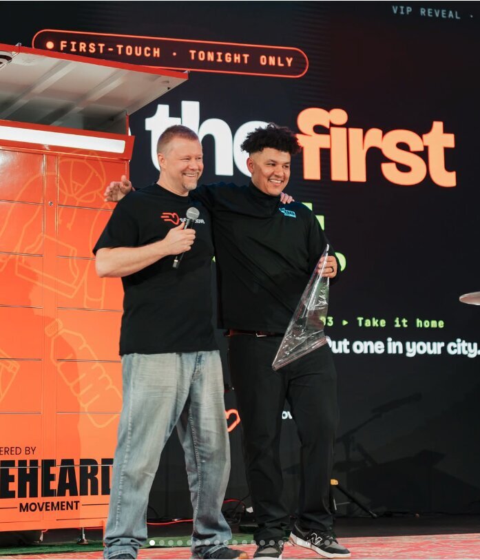 Justin and Evan reveal the first Serve.Love volunteer kiosk on stage